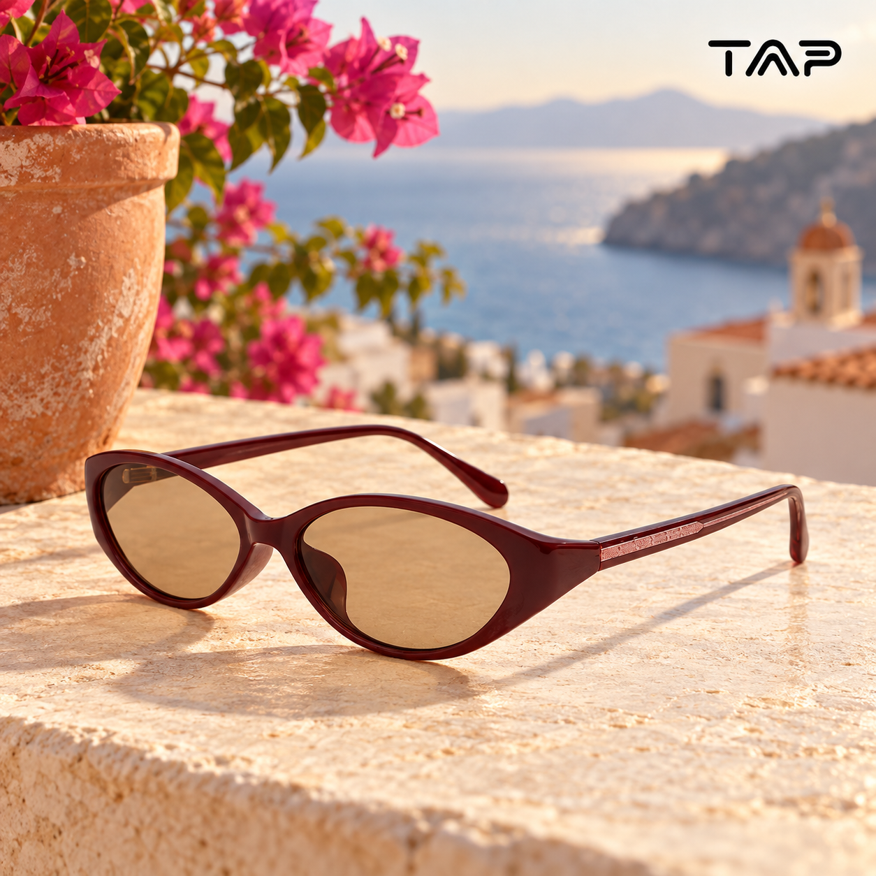 Burgundy cat-eye sunglasses in warm coastal evening light